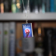 Load image into Gallery viewer, Winter Miniature Book Necklace in front of book shelves