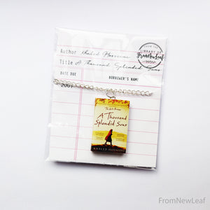 A Thousand Splendid Suns Miniature book necklace packaged in library card