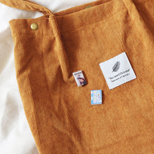 Load image into Gallery viewer, Two All the Bright places miniature book badges pin on a orange tote bag