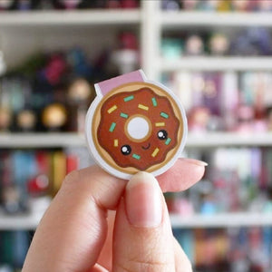 Hand holding donut magnetic bookmark fromnewleaf